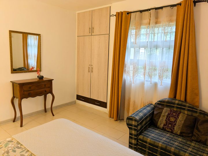 Bedroom with mirror and sitting nook
